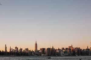 A city shot of New York City on a sunset evening taken from a far distance